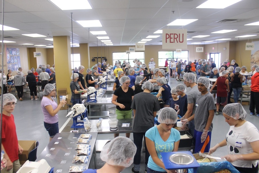 Students help distribute and pack food at Feed My Starving children after a day at orientation.