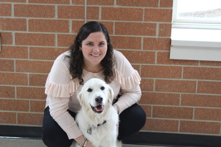 Social worker Amy Fitzgerald poses with her therapy dog Kensi. Both Fitzgerald and Kensi work toward a mutual goal of connecting and comforting students.