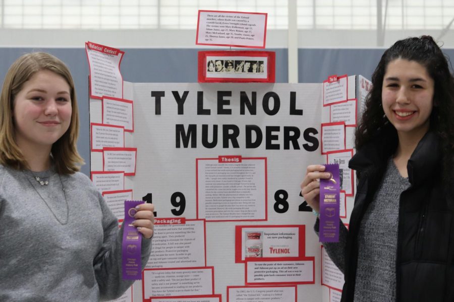 Juniors Elyse Tyler and Heather Berreles display their awards for their History Fair project on the Tylenol Murders.