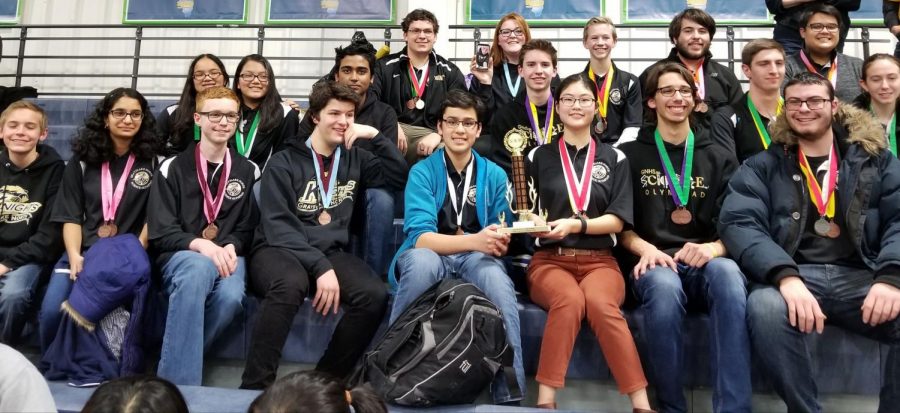 Members of the Science Olympiad team pose with their trophy from their Regional Competition where they placed to advance to State.