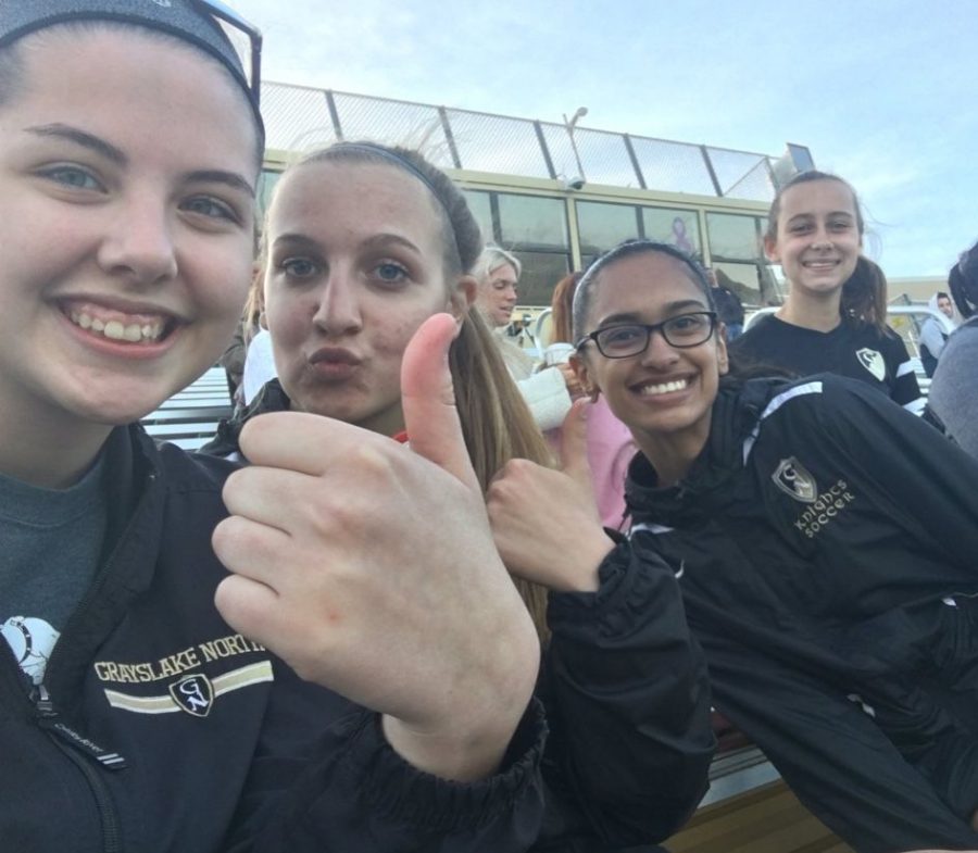 Juniors Megan Eppel, Abby Tompoles, Tanishka Sheth and freshman Ashley Plant take a picture at a soccer game as part of #The Whole Knight .