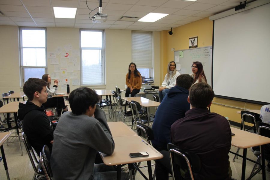 Graduates from Grayslake North visit with students in English classes.