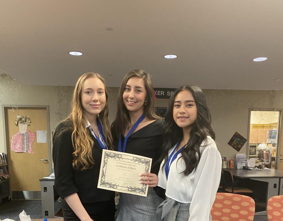 Senior members Nina Neilon (left), Anjie Rodriguez (center), and Rhea Sienes (right) show off their award for second place.