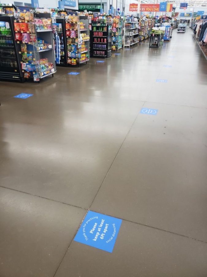 Walmart adds social distancing stickers on the floor so customers can stay a minimum of six feet apart, as per CDC guidelines.