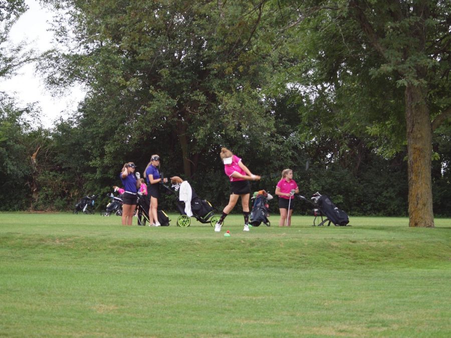 The girls golf team practices for their next match.