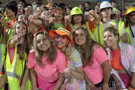 The superfans cheer on the Knights at a home football game. The theme was neon night.
