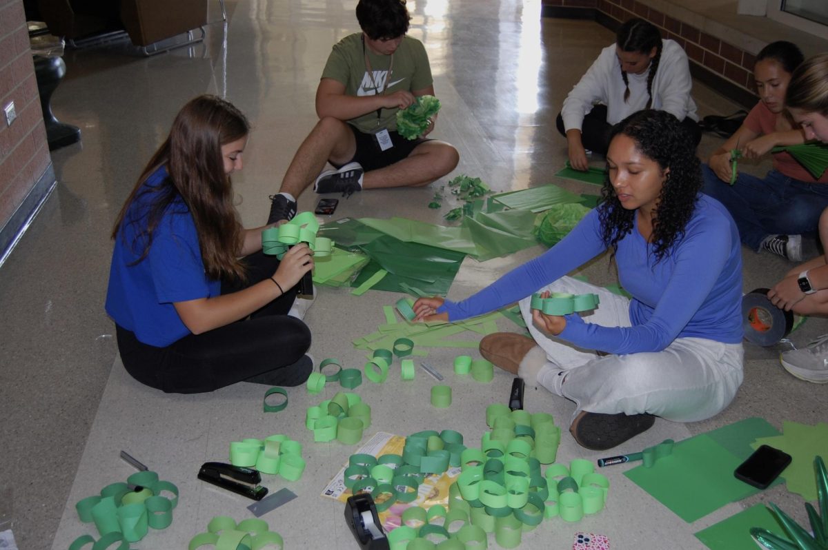 The sophomores craft their own green decorations to give their hallway a more unique touch.
