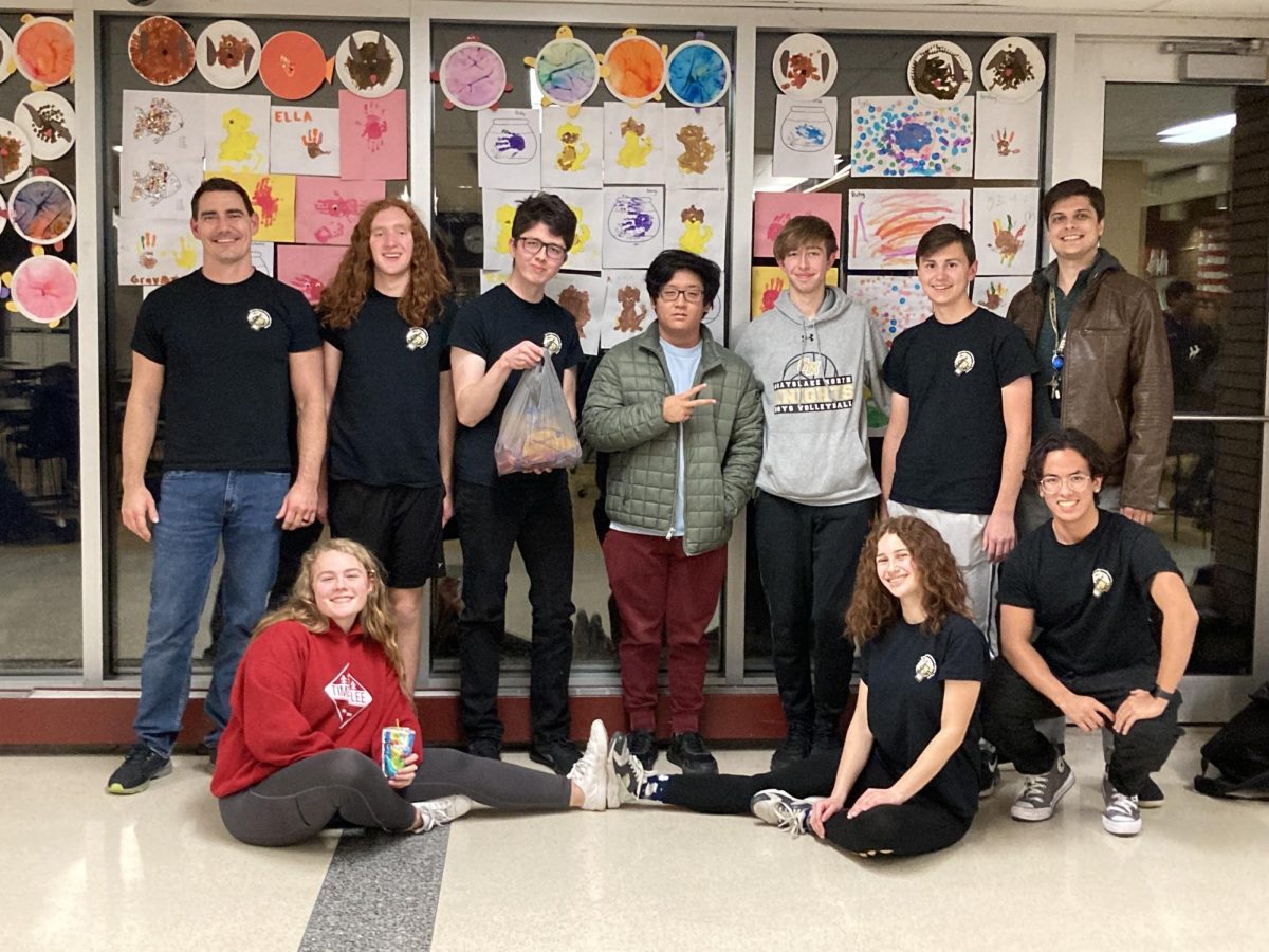 Having taken first in a miniature fun math contest secondary to the greater competition, the math team celebrates their spoils - a bag of candy. 